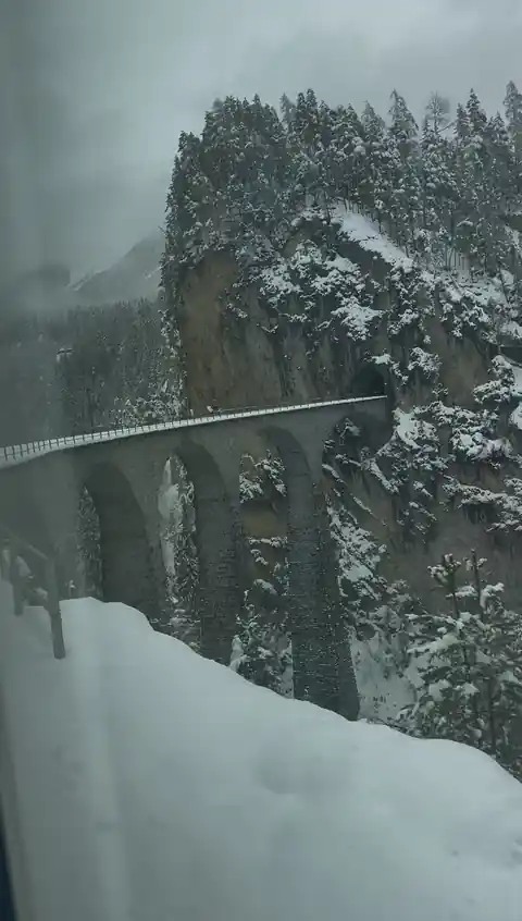 Stone railway viaduct on the Glacier Express route in winter, photographed by Libby