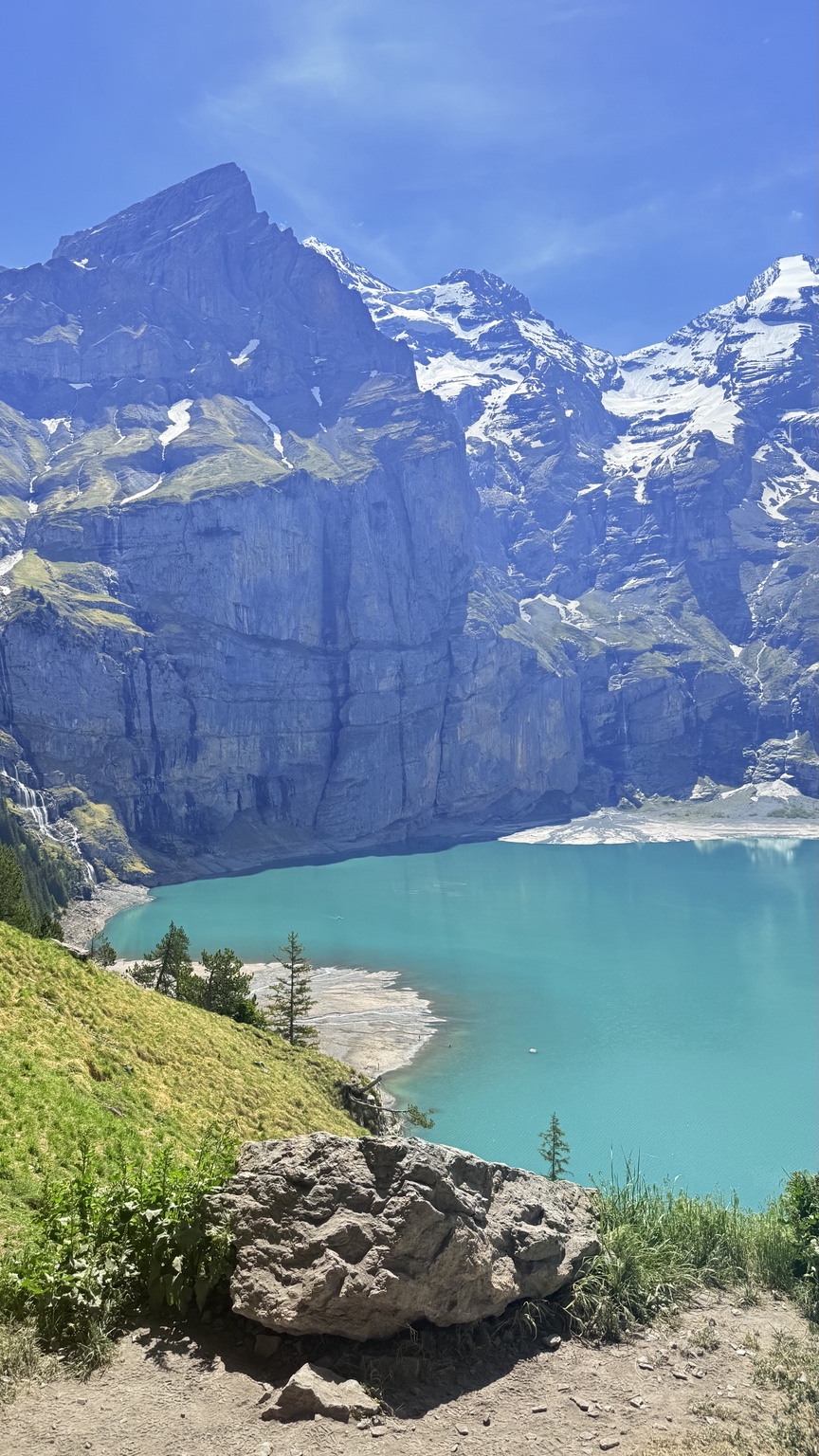 Elevated view across the turquoise Oeschinensee with forest and mountains