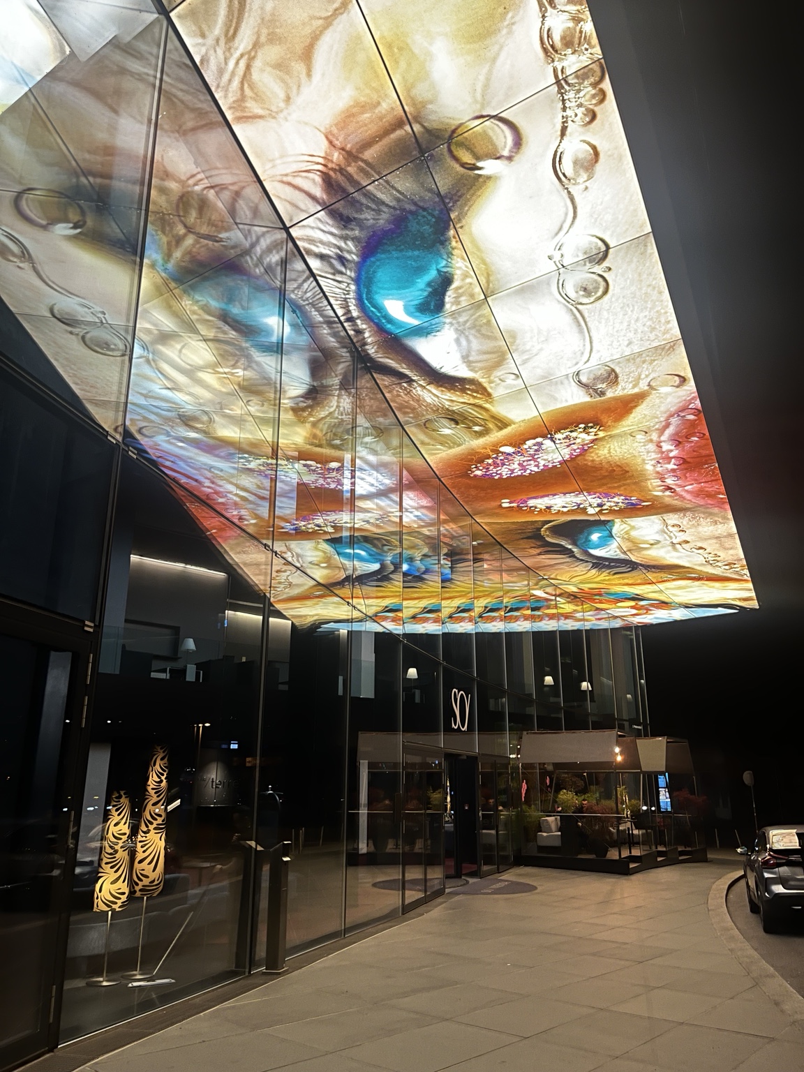 The illuminated glass canopy above SO/ Vienna at night